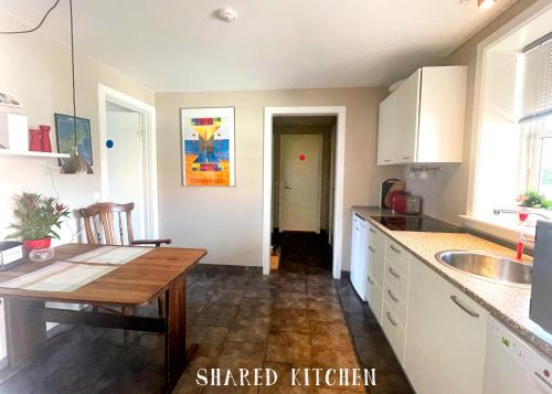 a kitchen with a wooden table and a counter top at Rørvig Bed & Kitchen in Rørvig