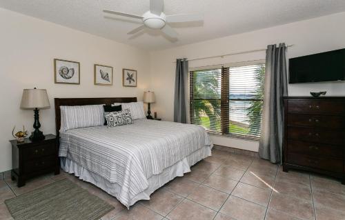 a bedroom with a bed and a ceiling fan at Georgetown Villas #201 in George Town