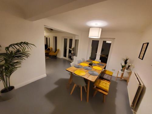 a dining room and living room with a table and chairs at 5 bedroom, recently renovated house close to Hastings Beach in Hastings
