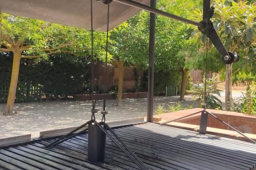 a swing set in a park with trees at Finca El Pilar in Madridejos
