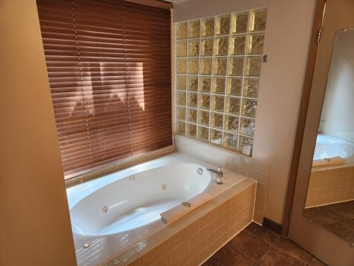 a bath tub in a bathroom with a window at Waterton Lakes Lodge Resort in Waterton Park