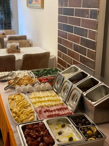 a buffet of different types of food on a table at Peaky Hotel in Durrës