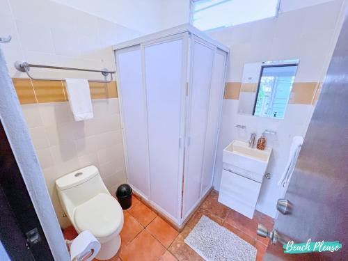 a bathroom with a toilet and a shower and a sink at Madison - 99 Steps to Beach in Golden Zone in Bucerías