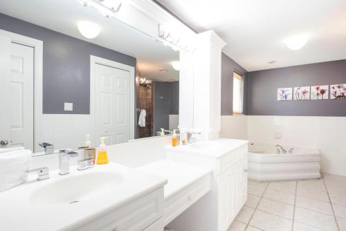 a bathroom with two sinks and a large mirror at On the Bay #103 Condo in Old Man Bay