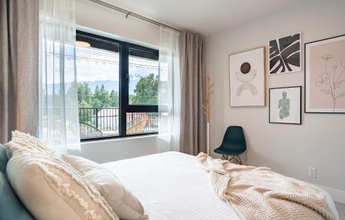 a bedroom with a bed and a window at Western Star by Revelstoke Vacations in Revelstoke