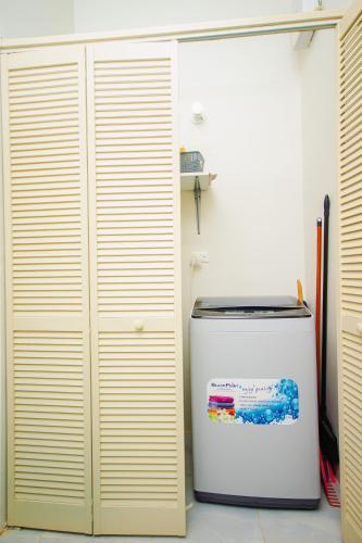 a white refrigerator in a room next to a wall at home with relaxing sea view in Discovery Bay