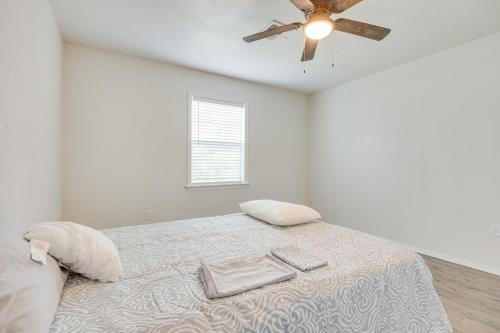 a white bedroom with a bed with a ceiling fan at Updated Mangum Home about 14 Mi to Quartz Mountain! in Mangum