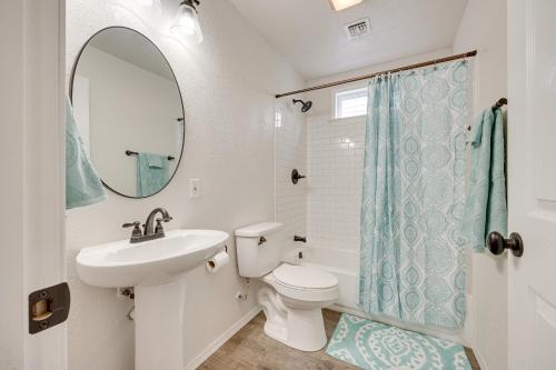 a bathroom with a sink and a toilet and a mirror at Updated Mangum Home about 14 Mi to Quartz Mountain! in Mangum