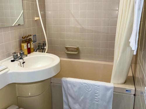 a bathroom with a sink and a bath tub at Ichihara Marine Hotel - Vacation STAY 51075v in Ichihara