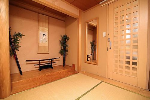 an empty room with a bench and a door at TOKYO HOUSE INN - Vacation STAY 02084v in Tokyo
