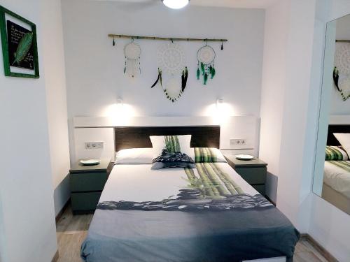 a bedroom with a large bed with two night stands at SOL & MAR Playa de las vistas Torres del Sol A504 in Arona