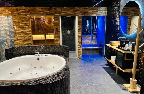 a large bathroom with a tub and a sink at Hotel de Prince in Nijmegen