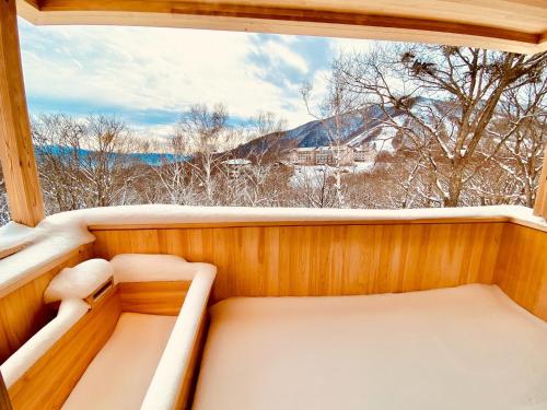 a sauna with a view of a snow covered mountain at Snowman apartments - Vacation STAY 15949v in Iiyama