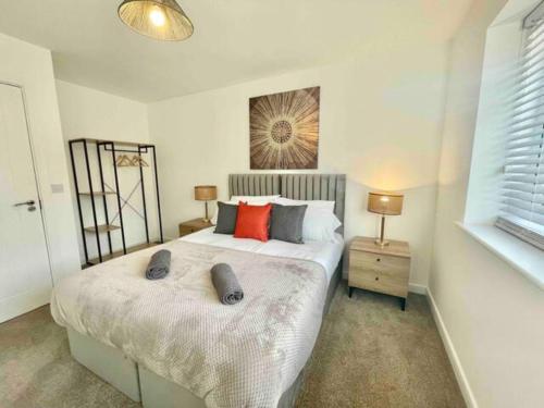 a bedroom with a bed with two pillows on it at Folkestone 3 Bedroom with private parking and EV car outlet near M20 easy access to Eurotunnel, Dover & Dungeoness in Sandgate