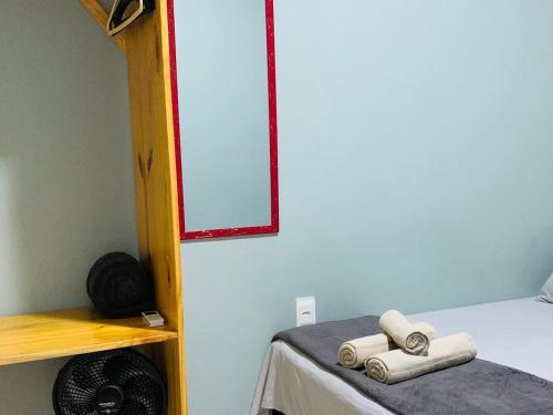 a room with a bed with two folded towels on it at Portuá Chalés in São Miguel dos Milagres