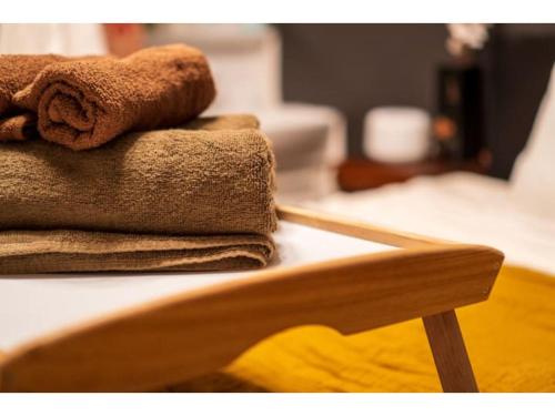 a stack of towels sitting on top of a bed at Hakugei Ryokan 2 - Vacation STAY 30359v in Tokyo