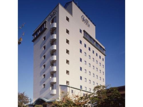 a tall white building with a clock on it at Hotel Socia - Vacation STAY 53739v in Hita