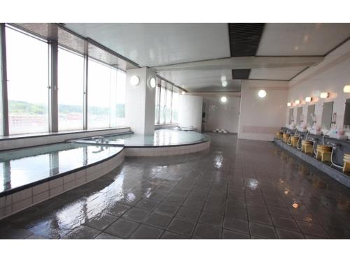 a large room with a swimming pool in a building at Hotel Socia - Vacation STAY 53771v in Hita