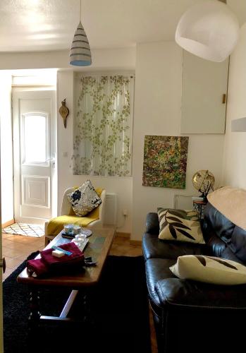 a living room with a couch and a table at Maison indépendante in Noyant-dʼAllier