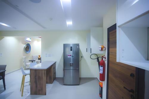 a kitchen with a fire hydrant and a refrigerator at Picturesque 3-bedroom Apartment in Yaba in Lagos