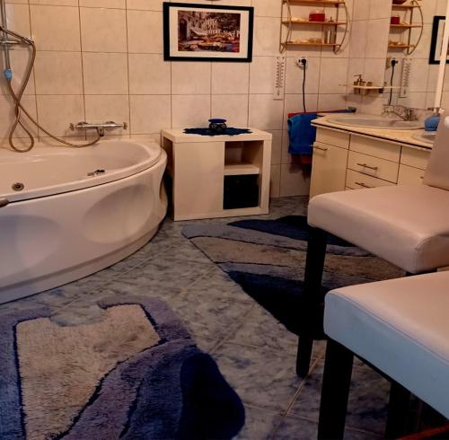 a bathroom with a bath tub and a sink at Apartment - MY DESTINATION in Slavonski Brod