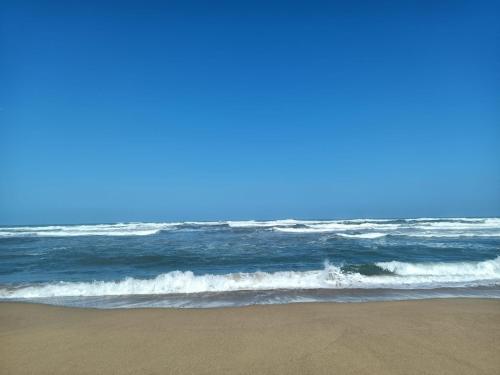 a sandy beach with the ocean in the background at Da Tziu Efisiu Mare e Relax nel Sinis in Baratili San Pietro