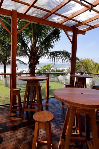 a patio with tables and chairs and a palm tree at Casa Cancun Hotel Boutique & Eventos in Penha