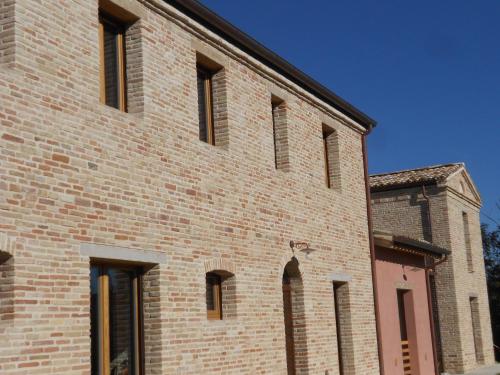 a large brick building with windows on the side of it at L'Isola Che Non C'era in Apiro