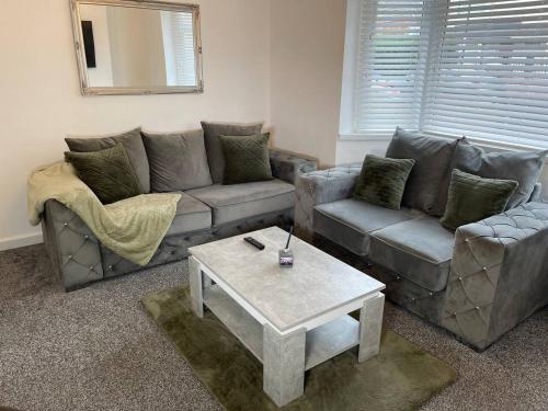 a living room with two couches and a coffee table at Redcar Retreat in Redcar