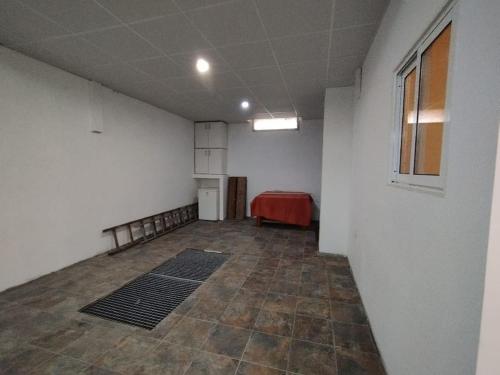 an empty room with a red couch in a room at Apartamento Carol in Reus