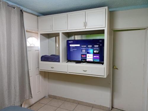a room with a tv in a white cabinet at Departamento #7 in San Felipe