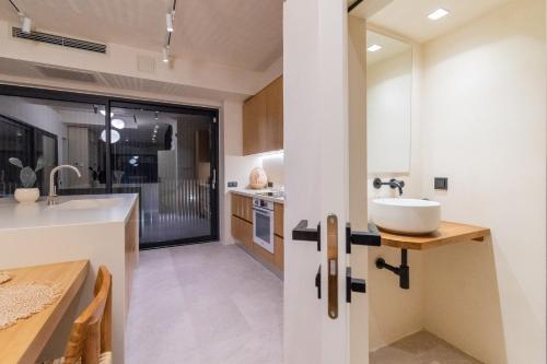 a kitchen with a sink and a counter top at SithoniaRS Luxury Three Floors Villa With Private Pool & Garden in Nikiti