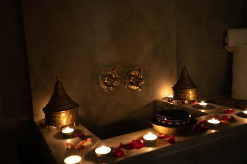 a room with candles and a table with a stove at Riad Fes Ziyat & Spa in Fès