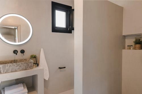 a bathroom with a mirror and a sink at Berthina House in Dhrakopouláta