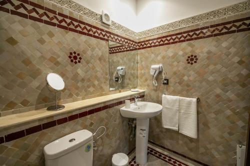 a bathroom with a toilet and a sink at Riad Fes Ziyat & Spa in Fès