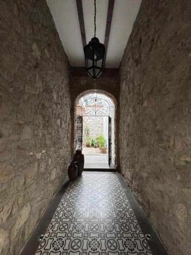 a hallway with a stone wall and a window at RAYON CANTERA in Morelia
