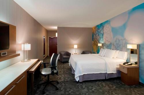 a hotel room with a bed and a desk at Courtyard by Marriott Scranton Montage Mountain in Moosic