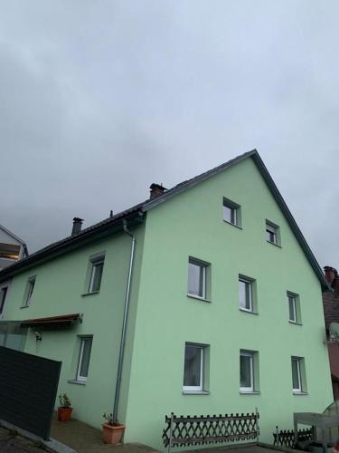 a large white building with a black roof at Haus CM in Nüziders
