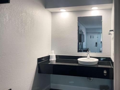 a bathroom with a sink and a mirror at Motel 6-Memphis, TN - Downtown in Memphis