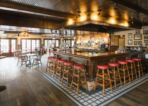 a bar with red stools in a restaurant at DoubleTree by Hilton Hotel & Suites Victoria in Victoria