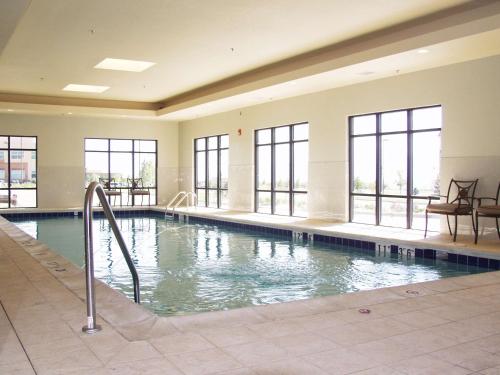 a large swimming pool with windows in a building at Hampton Inn & Suites Colorado Springs-Air Force Academy/I-25 North in Colorado Springs