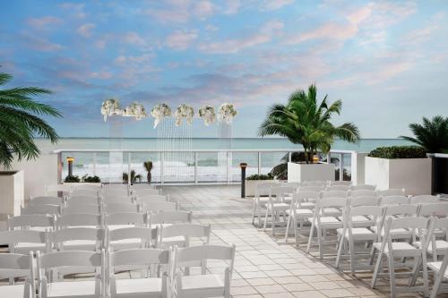 a wedding ceremony on the beach with white chairs at Hilton Cabana Miami Beach Resort in Miami Beach