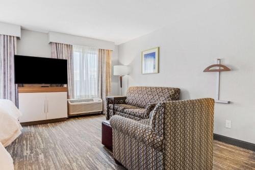 a hotel room with a chair and a television at Hampton Inn & Suites Colorado Springs-Air Force Academy/I-25 North in Colorado Springs