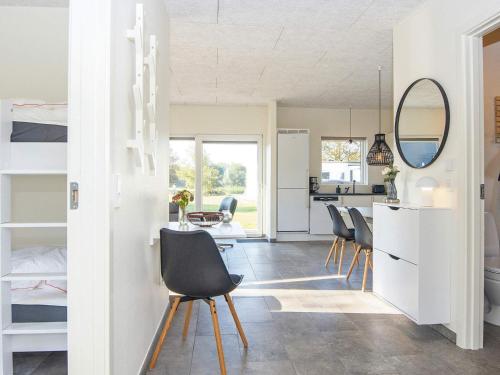 a kitchen and dining room with a table and chairs at Holiday home Ringkøbing LXXX in Ringkøbing