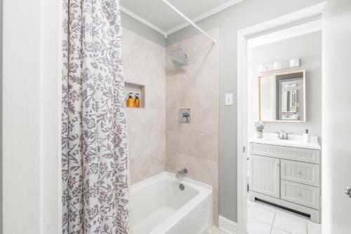 a bathroom with a tub and a shower curtain at Spotless 4BR near CLT Uptown, Fast Wi-Fi in Charlotte