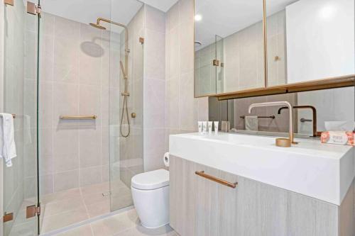 a bathroom with a toilet and a glass shower at 3 Bedrooms Apt in Glen Waverley central * parking in Glen Waverley
