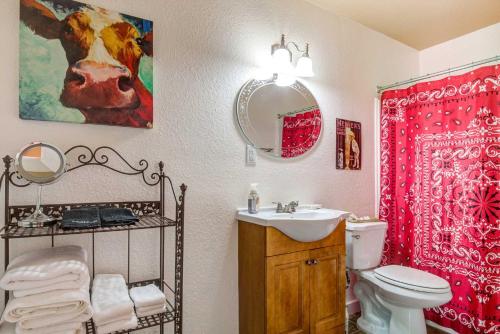 a bathroom with a sink and a toilet and a mirror at #2 Forge ~ Bandera Tin Star ~ Bandera, TX. in Bandera