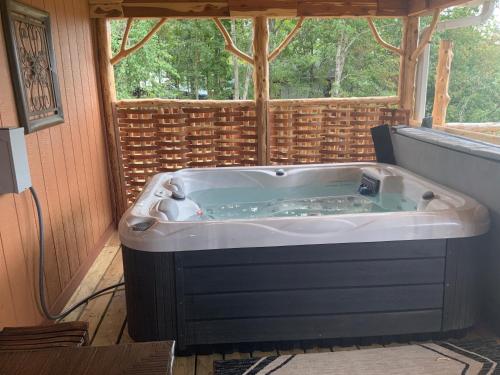 a jacuzzi tub in a room with a window at Cedar House in Rockaway Beach