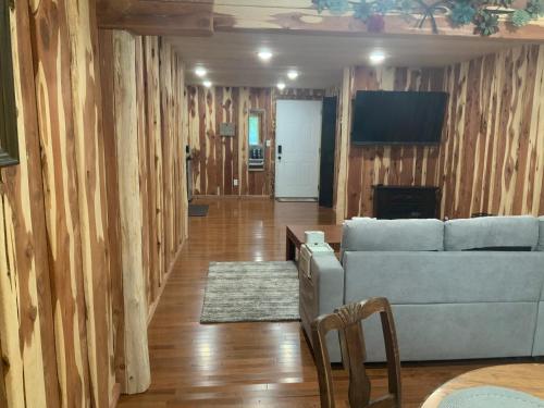 a living room with a couch and a tv at Cedar House in Rockaway Beach