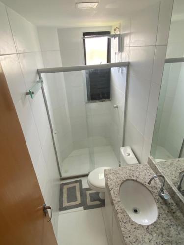 a small bathroom with a sink and a toilet at Loft de praia - Itacimirim BAHIA in Itacimirim
